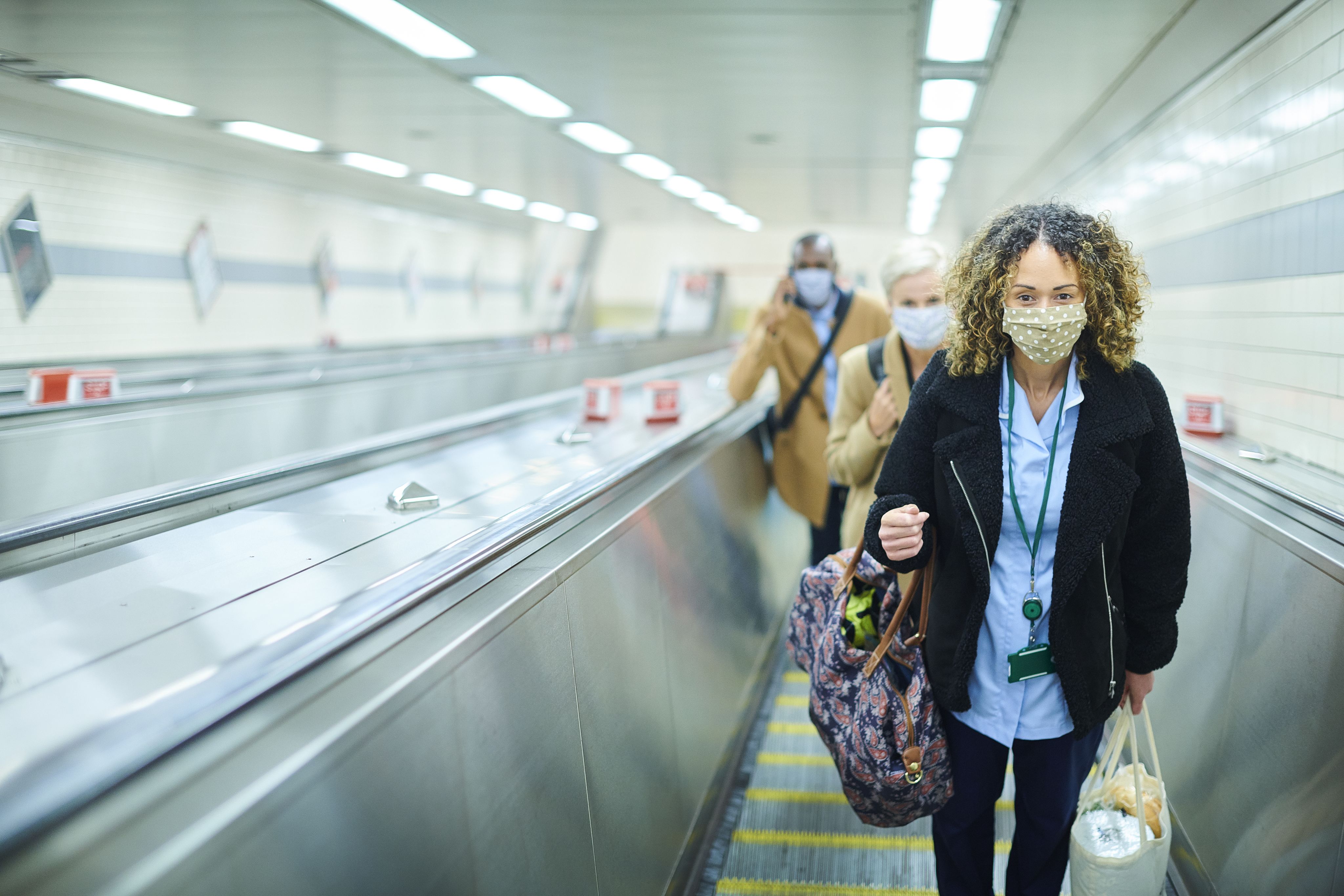 NHS worker carrying groceries home on the Tube