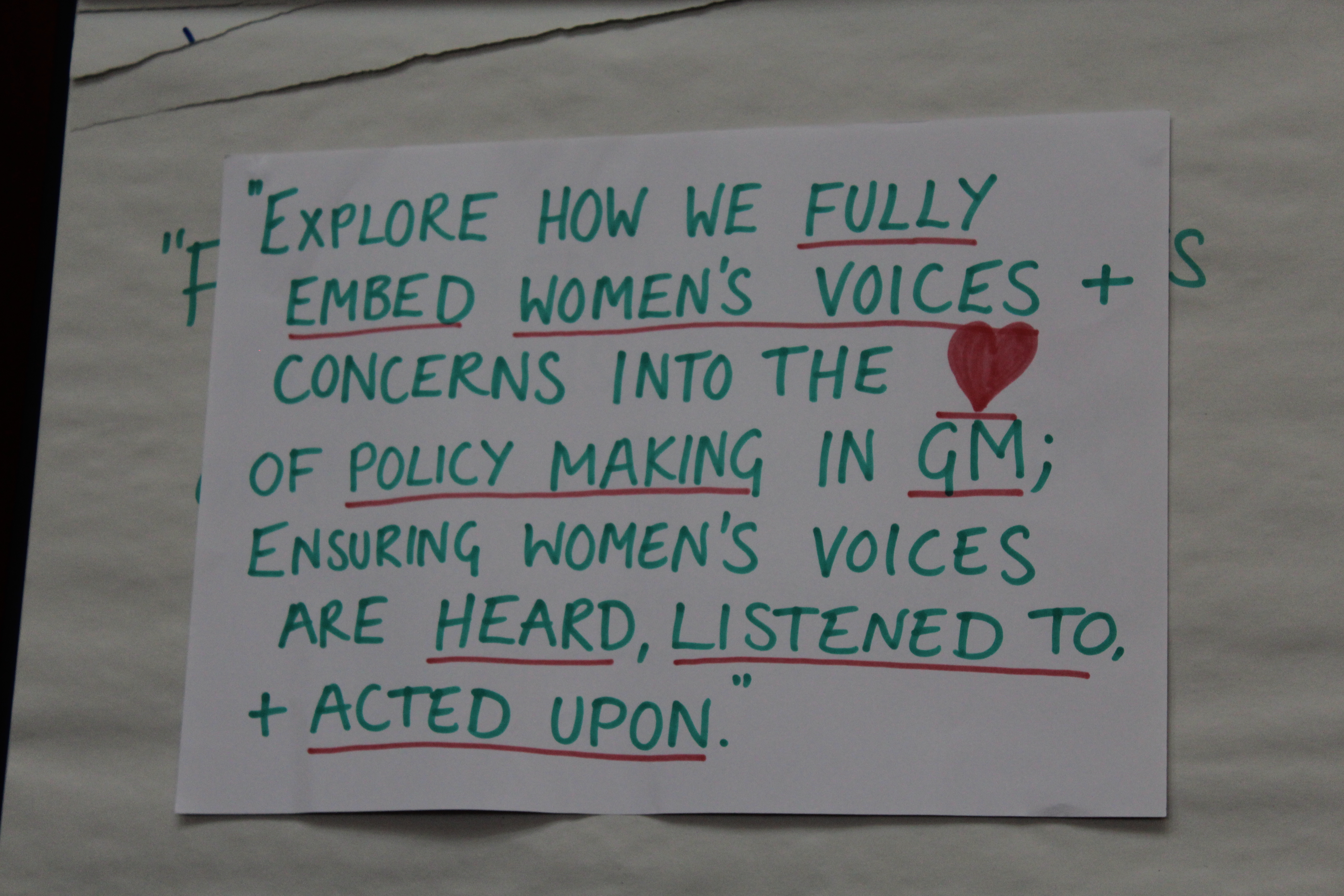 Poster from the case study that reads "Explore how we fully embed women's voices and concerns into the heart of policymaking in Greater Manchester; ensuring women's voices are heard, listened to, and acted upon"