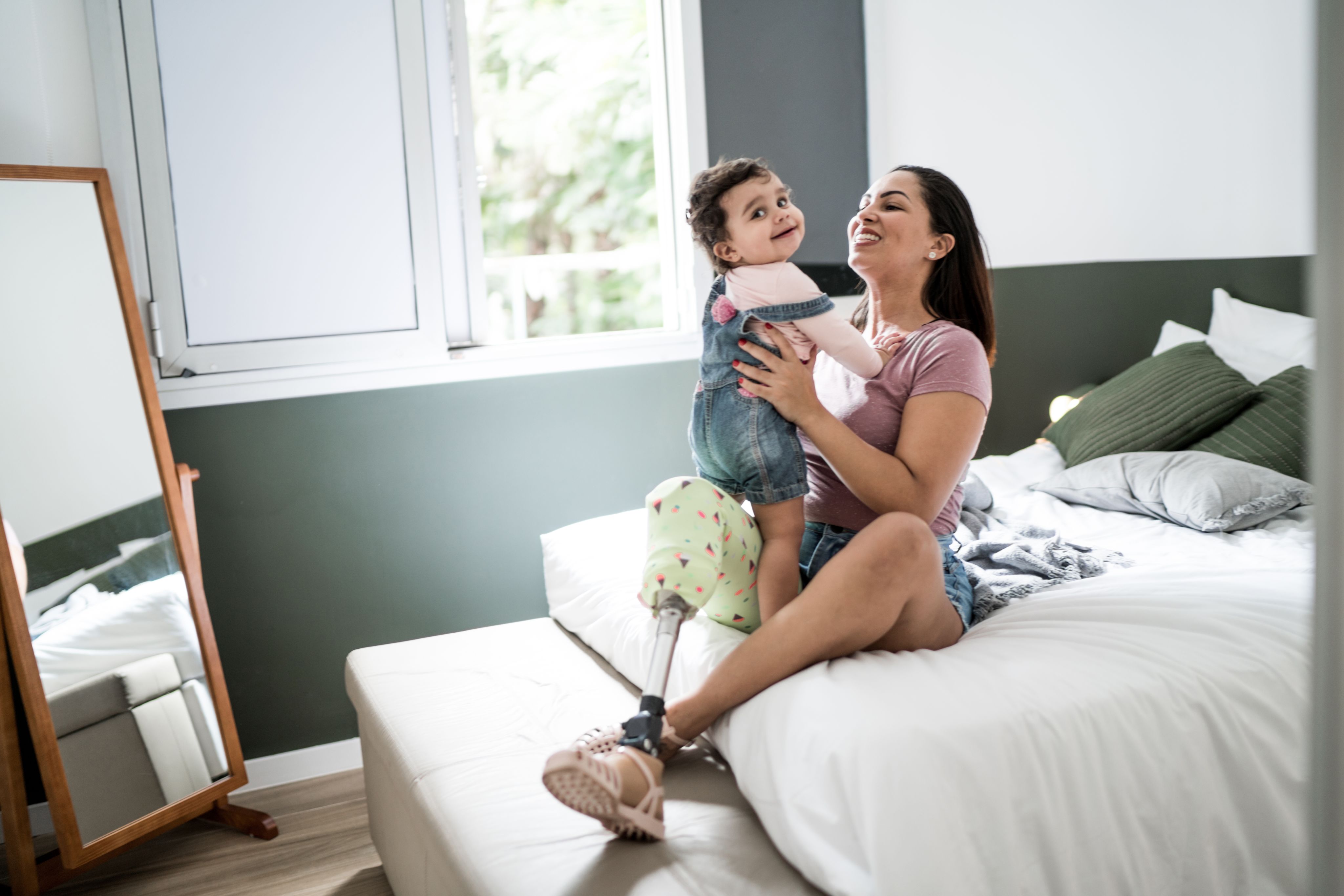 A disabled woman playing with her baby
